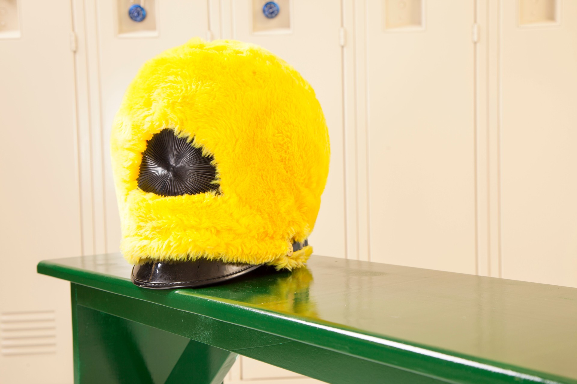 Music: Marching band hat on bench in school locker room.
