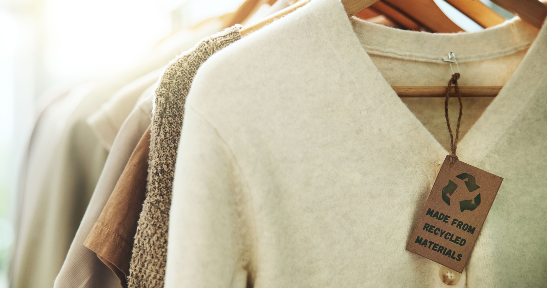 Shopping, store and clothes on rack for recycling, sustainability and recycled material. Fashion, designer boutique and tag on textile, clothing and fabric for discount, promotion and retail sale